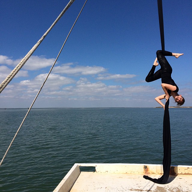 Yes, that is a beautiful woman doing aerial silks on a moving shrimp boat. #TexasGulf #yoga #lifeisinteresting